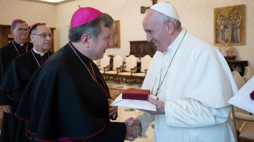 Bishop McClory shakes hands with the Holy Father
