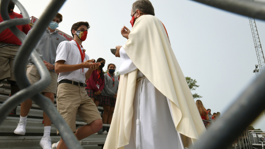 Bishop McClory distributes the Eucharist at an all-school Mass at Andrean Sept. 14, 2020