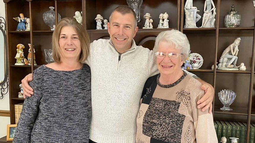 David Moore, diocesan property manager, is surrounded by his sister Debbie Anderson (left) and mother Irene Moore (right), 87, at his mom's home in Portage on April 21. 