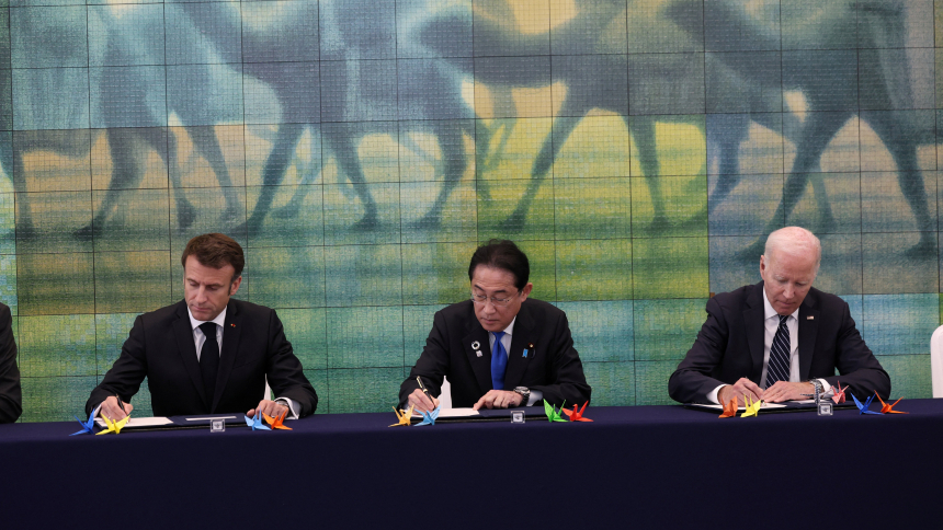 French President Emmanuel Macron, Japanese Prime Minister Fumio Kishida, and U.S. President Joe Biden, sign a guest book as they visit Peace Memorial Museum with other G7 leaders as part of the G7 leaders' summit in Hiroshima, Japan, May 19, 2023. (OSV News photo/Ministry of Foreign Affairs of Japan handout via Reuters)