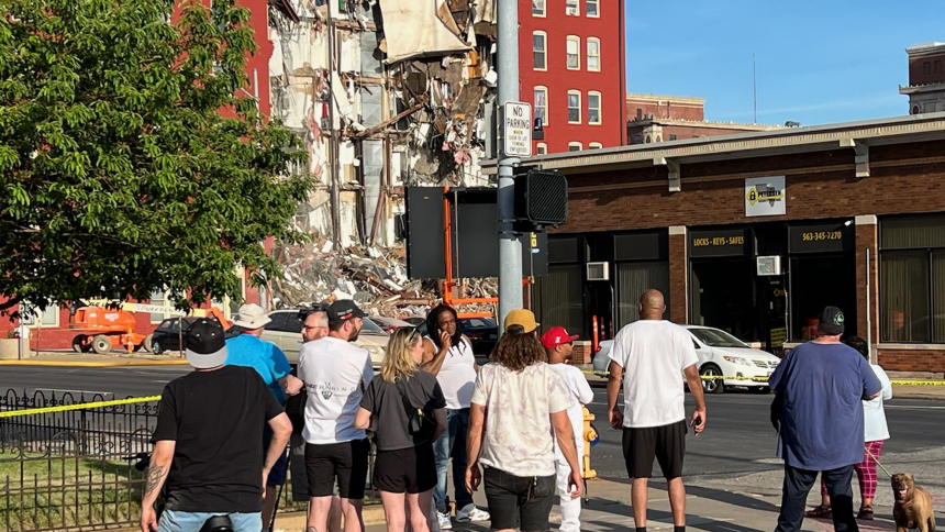 People stand outside looking at a partially collapsed apartment building in Davenport, Iowa, May 28, 2023. The Quad-City Times reported that a ninth person was rescued the following day as some residents remain unaccounted for and officials made plans to demolish the remaining structure. (OSV News photo/John Blunk, courtesy The Catholic Messenger)