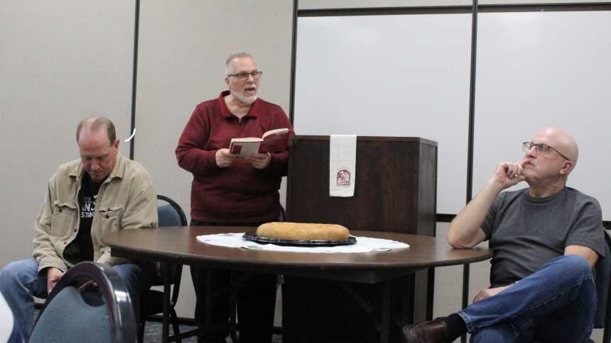 acilitator Joe De Frier (standing), coordinator of Adult Faith Formation, presented a skit, "The Bread That Remembered," about two brothers (from left, Michael Croarkin and Gary Peterson) who lost their gentleness and goodness until a woman left a loaf of bread for them, during the second session of a series on "Re-discovering the Eucharist" offered at St. Paul in Valparaiso on May 8, 15 and 22. "They shared (the bread) and found the goodness that the bread remembered," said De Frier of the symbol of the Ho