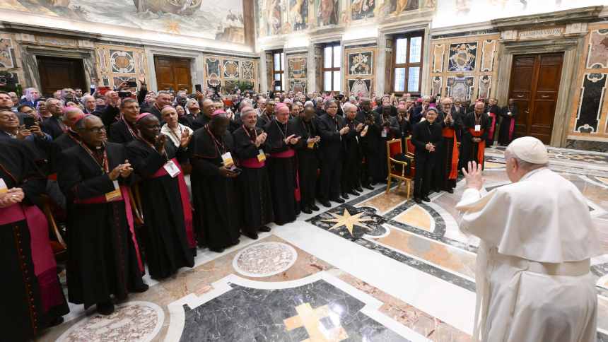 Pope Francis waves to participants in the general assembly of Caritas Internationalis at the Vatican May 11, 2023. In the front row at the right are: Cardinal Luis Antonio Tagle, former president of the umbrella organization for Catholic charities around the world; Michael Czerny, prefect of the Dicastery for Promoting Integral Human Development; and Cardinal Soane Mafi of Tonga. (CNS photo/Vatican Media)