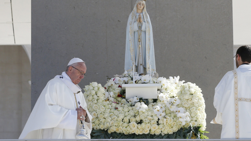 Pope Francis uses incense as he venerates a statue of Our Lady of Fatima during the canonization Mass of Sts. Francisco and Jacinta Marto, two of the three Fatima seers, at the Shrine of Our Lady of Fatima in Portugal, May 13, 2017. The Vatican announced the pope will return to Fatima Aug. 5 while in Portugal for World Youth Day. (CNS photo/Paul Haring)