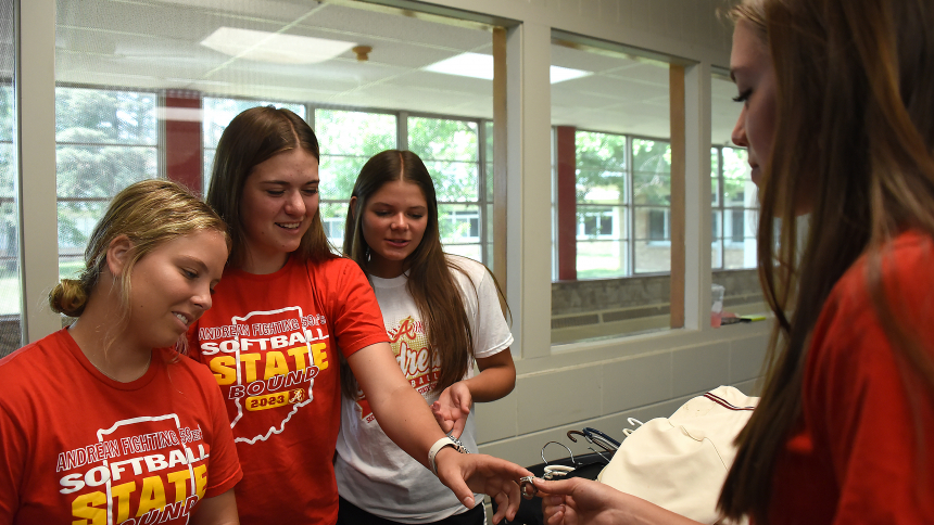 Andrean High School softball players (left to right) Abbey Bond, Maggie Voliva, Sadie Drousias and Libby Voliva view a proposed ring design to commemorate their  2023 state champion runners-up season, at the AHS athletic office in Merrillville on June 21. The Lady 59ers came up shy of a title, losing 3-0 to the North Posey Vikings of Poseyville to close out their 29-8 season. (Anthony D. Alonzo photo)