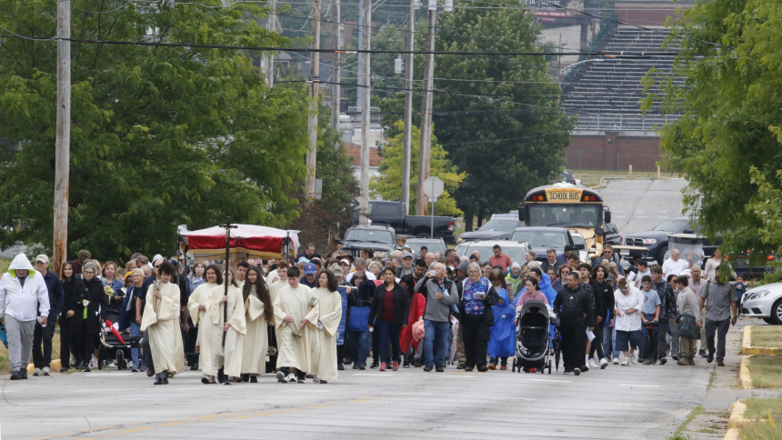 Hundreds of people walk along Washington St. as they participate in the Michigan City Corpus Christi procession. (Bob Wellinski photo)