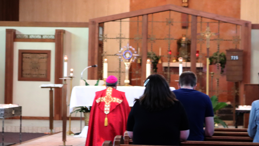 Bishop Robert J. McClory presides over a Eucharistic Holy Hour for youth on June 2 at St. John Bosco in Hammond. The Diocesan Youth Council, made up of teens from around the diocese who help plan faith-related events for their peers, sponsored the event. (Cecilia Cicone photo)
