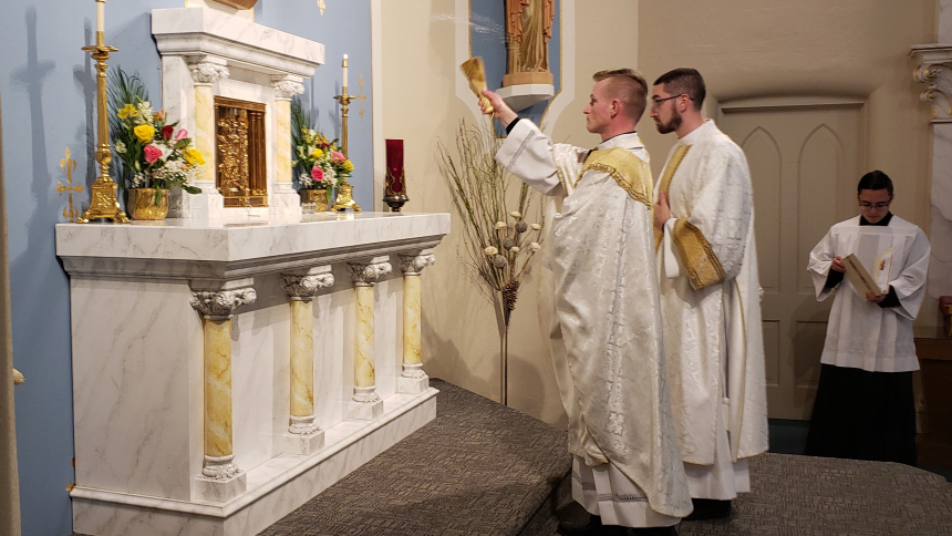 Father Nate Edquist, pastor of Holy Family Parish, blesses the new high altar at St. Joseph church in LaPorte during Mass on May 14. (Bob Wellinski photo)