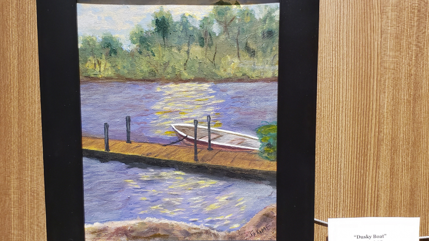 A painting titled, "Dusky Boat" by Father Dave Kime hangs in the Queen of All Saints Legacy Center along with other works by Father Kime, Father Roque Meraz, and Dr. John Wilhelm until the first of July. (Bob Wellinski photo)