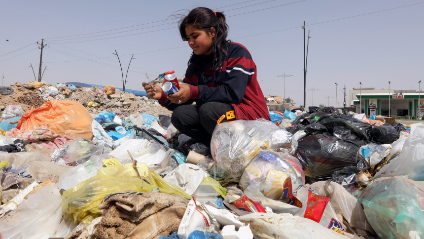 Sahar Shaaban, 11, an Iraqi girl who provides for her family, collects cans from a garbage area in Kirkuk, Iraq, April 21, 2021. (CNS photo/Ako Rasheed, Reuters)