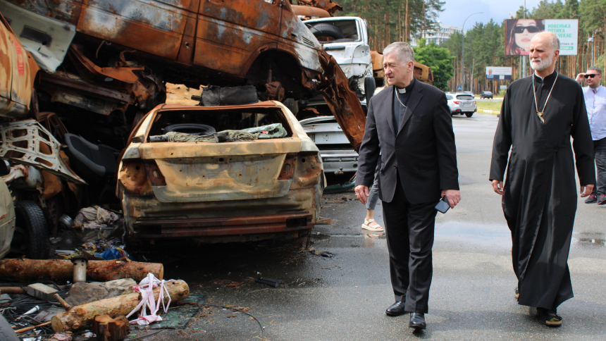 In this June 29, 2023 image, Chicago Cardinal Blase J. Cupich and Metropolitan Archbishop Borys Gudziak of the Ukrainian Catholic Archeparchy of Philadelphia inspect a memorial near Irpin, Ukraine made of cars shelled by Russian troops as Ukrainian civilians attempted to flee the area in 2022. (OSV News photo/Gina Christian)