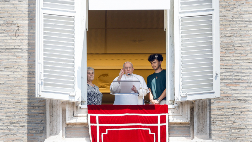 Pope Francis, alongside a young person who was going to attend World Youth Day and his grandmother, speaks to visitors gathered in St. Peter's Square at the Vatican before praying the Angelus July 23, 2023. (CNS photo/Lola Gomez)