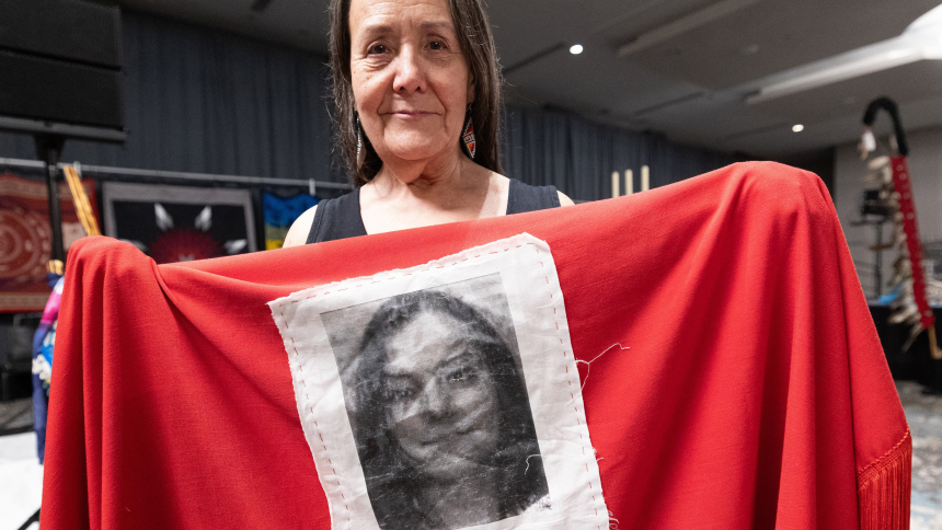 Kathleen Mishow of Gitchitwaa Kateri in Minneapolis holds a shawl with a picture of her daughter, Kateri Marie Mishow, sewn on the back during the first day of the Tekakwitha Conference July 20, 2023, in Bloomington, Minn. Kateri has been missing since 2007. (OSV News photo/Dave Hrbacek, The Catholic Spirit)