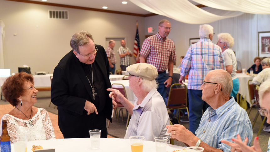 Bishop Robert J. McClory (second from right) speaks to Paul Young (center) and others gathered at the American Legion Post 403 in Wanatah for a Pub Theology presentation about the Eucharist sponsored by the Catholic Communities on July 20. The bishop provided an overview of the Kerygma - or a proclamation of the Gospel truths of salvation - as well as apologetics regarding the institution of the Eucharist. (Anthony D. Alonzo photos)
