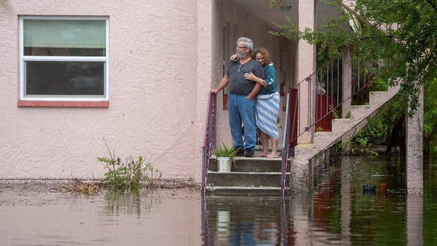Ken and Tina Kruse stand next to their apartment in Tarpon Springs, Fla., Aug. 30, 2023, after the area was flooded by the Hurricane Idalia, which made landfall in Florida as a Category 3 storm. It unleashed devastation along a wide stretch of the Gulf Coast, submerging homes and vehicles, turning streets into rivers, unmooring small boats and downing power lines before sweeping into Georgia. (OSV News photo/Greg Lovett, USA Today Network via Reuters)