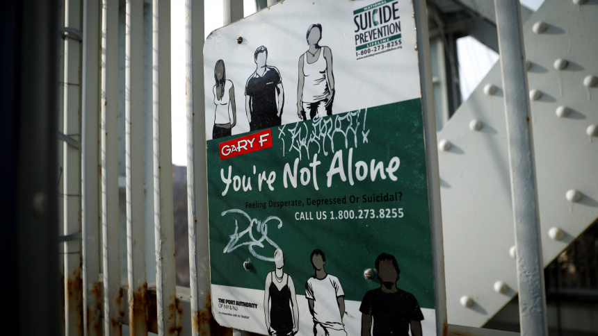 A suicide prevention sign is pictured on a protective fence on the walkway of the George Washington Bridge in New York City Jan. 12, 2022. (OSV News photo/Mike Segar, Reuters)