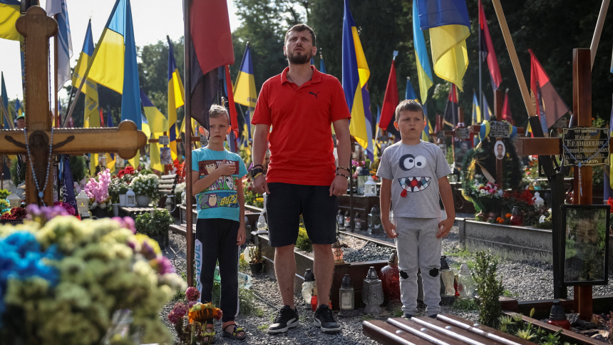 A family mourns on Independence Day in Lviv, Ukraine, Aug. 24, 2023, as they visit the tomb of a relative, a Ukrainian serviceman who was killed in a fight against Russian troops amid Russia's attack on Ukraine. (OSV News photo/Roman Baluk, Reuters)