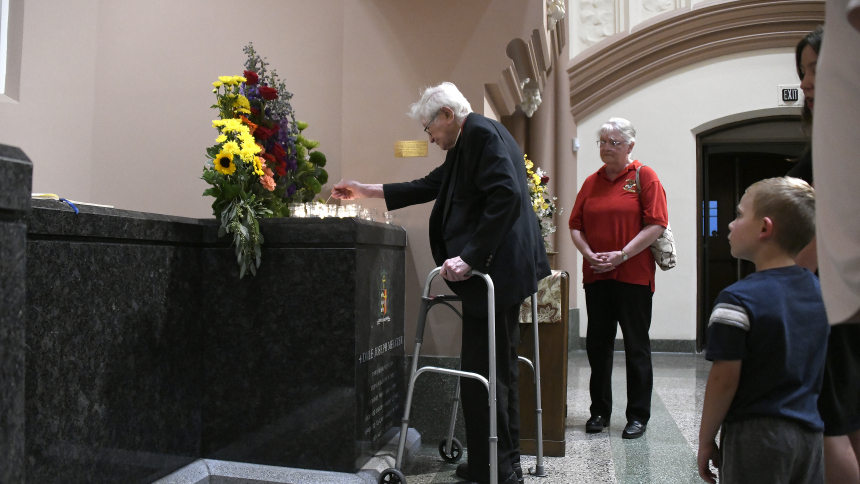 Senior priest Father Alphonse Skerl (left) pays tribute to the late Bishop Dale J. Melczek as Judy Holicky (center) Jacob Werhowatz-Nieman, 5, (right) look on at the third bishop of Gary's crypt during the Mass of Remembrance at the Cathedral of the Holy Angels in Gary on Aug. 25. Family, friends and clergymen gathered to pay tribute to and offer prayers for Bishop Melczek, who died on Aug. 25, 2022 after serving in the Diocese of Gary for 30 years. (Anthony D. Alonzo photo) 
