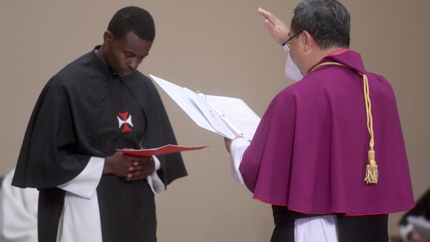 Brother Eric Kalimbiriro Kadalikashereza renews his vows and is blessed by Crosier Father Laurentius Tarpin, master general of the order, during a special Mass at Holy Cross Priory in Onamia, Minn., Aug. 18, 2023. (OSV News photo/Dianne Towalski, The Central Minnesota Catholic)