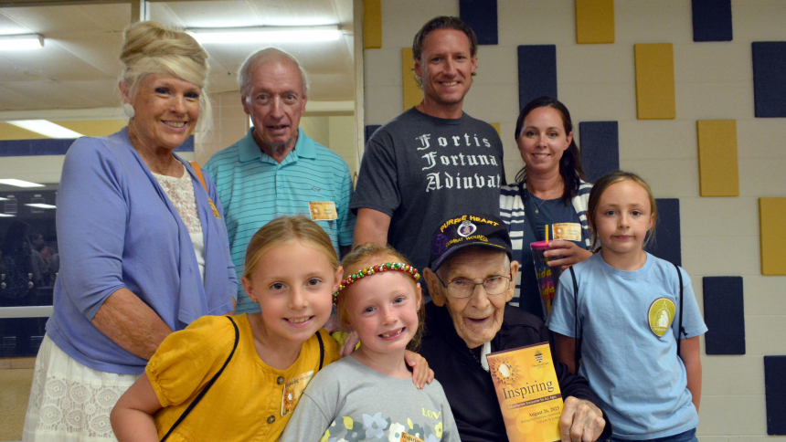 Ninety-seven-year-old Philip J. Schouten (front, second from right) of Schererville is gathered with grandchildren, great-grandchildren and in-laws at the Inspiring Presence event at Bishop Noll Institute in Hammond on Aug. 26. Schouten, a WWII Purple Heart recipient and double amputee, participated at the diocesan conference, which included Mass presided over by Bishop Robert J. McClory, Adoration of the Blessed Sacrament and presentations by guest speakers including author Dr. Scott Hahn. (Anthony D. Alon