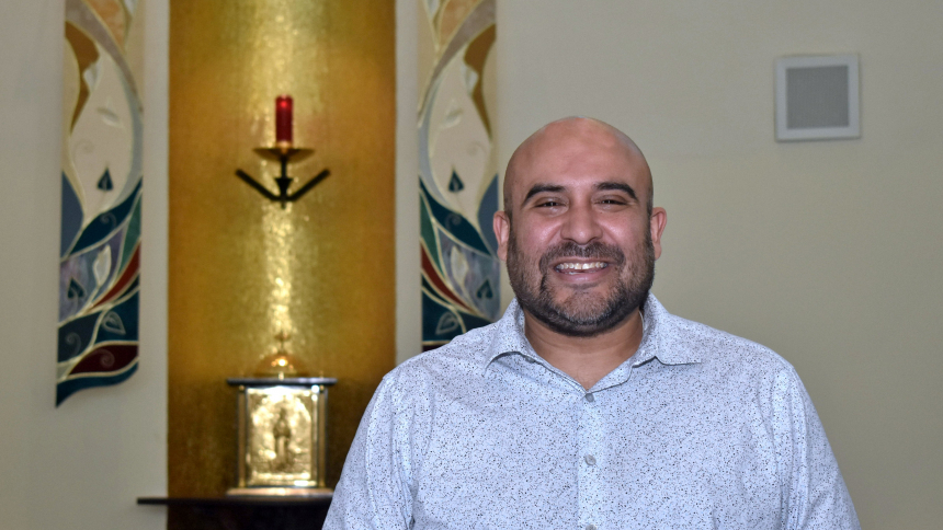 Richard Carrillo poses Aug. 9, 2023, in front of the altar in the chapel of St. John Neumann Church, Miami, where he directs the choir. He's organizing a Mass that blends Aztec and European heritages, "Mass of the Americas," by Los Angeles composer Frank La Rocca, and it will have its Miami premiere the evening of Oct. 3 at Epiphany Church, also in Miami. (OSV News photo/Jim Davis, Florida Catholic)