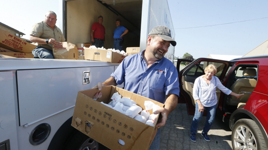 Volunteers load packages of ground meat into vehicles during  Operation Feed LaPorte County's distribution pickup on Aug. 22 at the LaPorte County Fairgrounds. (Bob Wellinski photo)