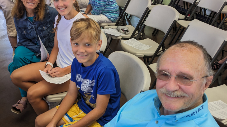 Raynelle Howlett (left) attend St. Teresa of Avila's outdoor Mass in downtown Valparaiso on Aug. 27, with her daughter Malia Howlett, 15, son Ryan Howlett, 10, and father Ray Brown. Chairs were set up at the William E. Urshel Pavilion for the 11 a.m. Mass, which was attended by more than 500 people. (Lynda J. Hemmerling photo)