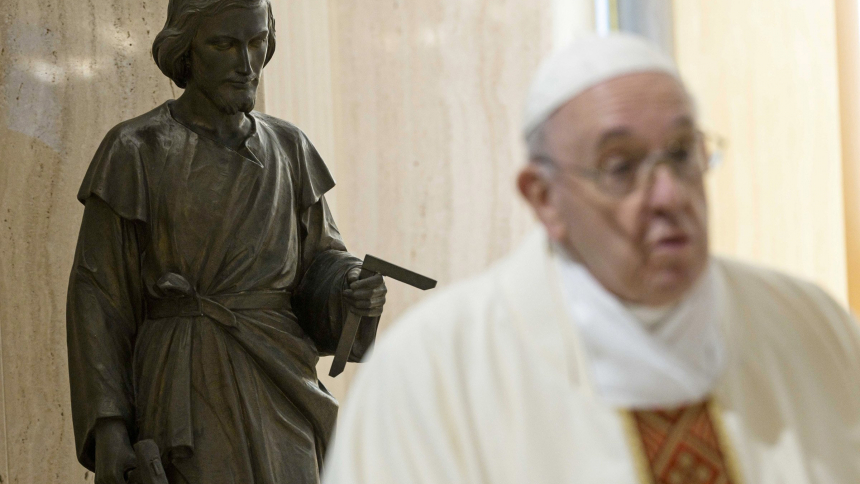A statue of St. Joseph is seen as Pope Francis celebrates morning Mass in the chapel of his residence, the Domus Sanctae Marthae, at the Vatican in this May 1, 2020, file photo. The Vatican has released the pope's message for the 2021 World Day of Prayer for Vocations, celebrated April 25 and dedicated to St. Joseph. (CNS photo/Vatican Media) 
