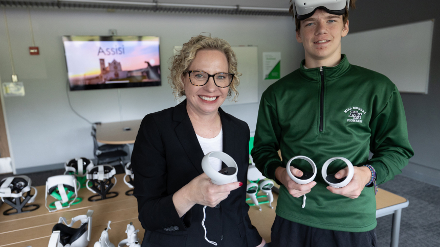 Melissa Dan, president of Hill-Murray School in Maplewood, Minn., and Aiden Kelly, a sophomore this year, hold equipment used in the school's virtual reality lab Aug. 18, 2023. (OSV News photo/Dave Hrbacek, Catholic Spirit)