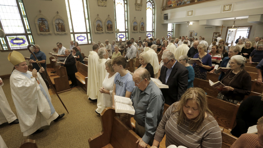 Bishop Robert J. McClory blesses the faithful at St. Mary's in Otis during the recessional following mass on Sept. 10. The parish celebrated their 150th anniversary. (Bob Wellinski photo)