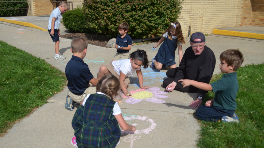 Father Jon Plavcan spends time with students at St. Patrick School during recess on Oct. 4  The pastor of the Chesterton parish said their is joy in being assigned to church with a school as he is able witness the children grow in their faith. (Erin Ciszczon photo) 
