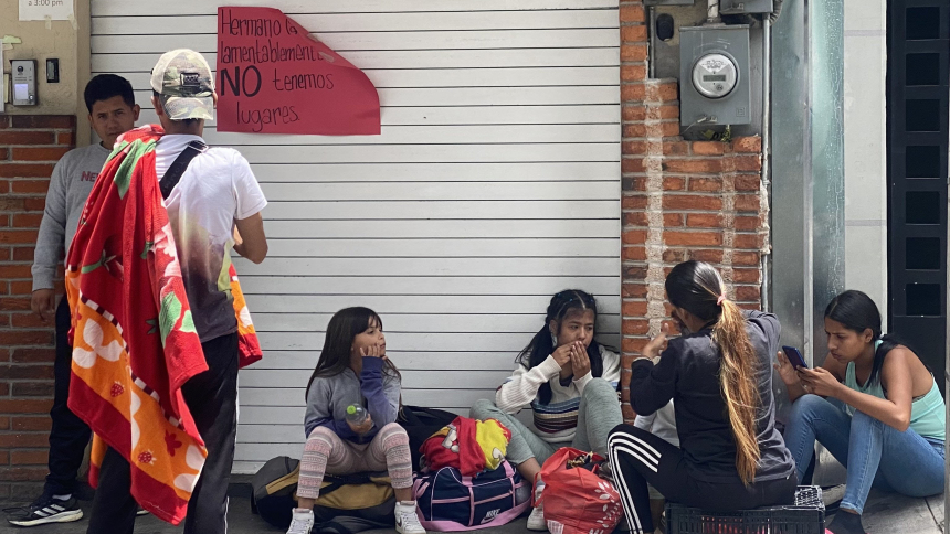 Migrants rest outside the CAFEMIN shelter in Mexico City Aug. 24, 2023, near a sign on the door that says there is no more room inside. With the growing number of migrants heading toward the U.S., shelters along the route from South America to the U.S. southern border are beyond capacity to help. (OSV News/photo/Rhina Guidos, Global Sisters Report)