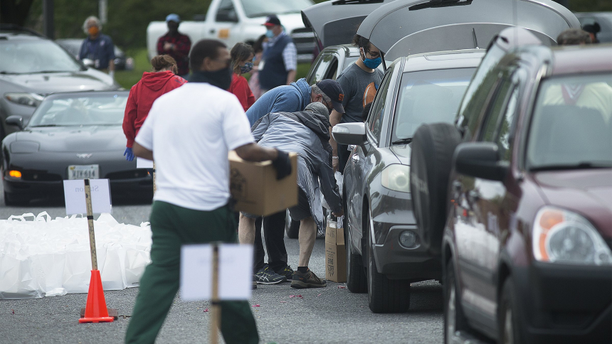 Catholic Charities staff and volunteers in the Archdiocese of Washington distribute boxes of nutritious grocery items to families in need in the parking lot of the Basilica of the National Shrine of the Immaculate Conception May 19, 2020. Among its seven themes, Catholic social teaching emphasizes an option for the poor and vulnerable, calling Catholics to "imitate Christ's love for the poor by working to create a society where the needs of the poor are always considered first." (OSV News photo/CNS file, Ty