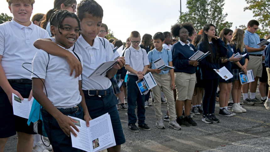 Among students gathered from several local Catholic schools, Donald Sherls (front. left) and Oscar Oceguera (front, right), sixth graders from St. Mary School of Griffith, join in fellowship and song at the annual Respect Life Prayer Service on Oct. 4 at the Franciscan Health campus in Dyer. The event included prayer, song, Scripture readings, memorializing the lives lost to abortion and testimonies from medical professionals who offer neonatal care and support of women. (Anthony D. Alonzo photo)