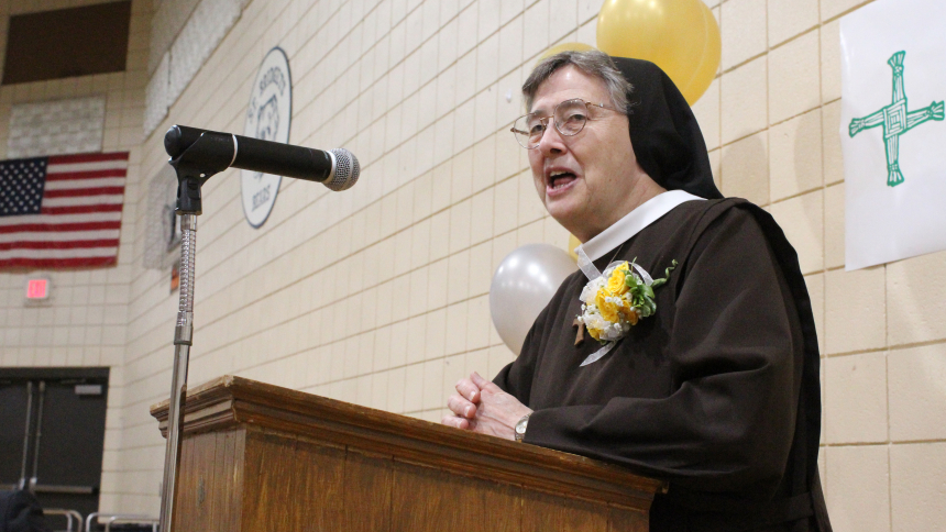 Sister Anita Holzmer, a 1965 graduate of the former St. Bridget School and one of 13 daughters of St. Bridget in Hobart to enter religious life, addresses the 150th anniversary dinner crowd on Sept. 30, teling them "it is so great to be part of a parish where people live their faith." She also saluted the Servite Sisters, "who taught me the joy of religious life" as her teachers. (Marlene A. Zloza photo)