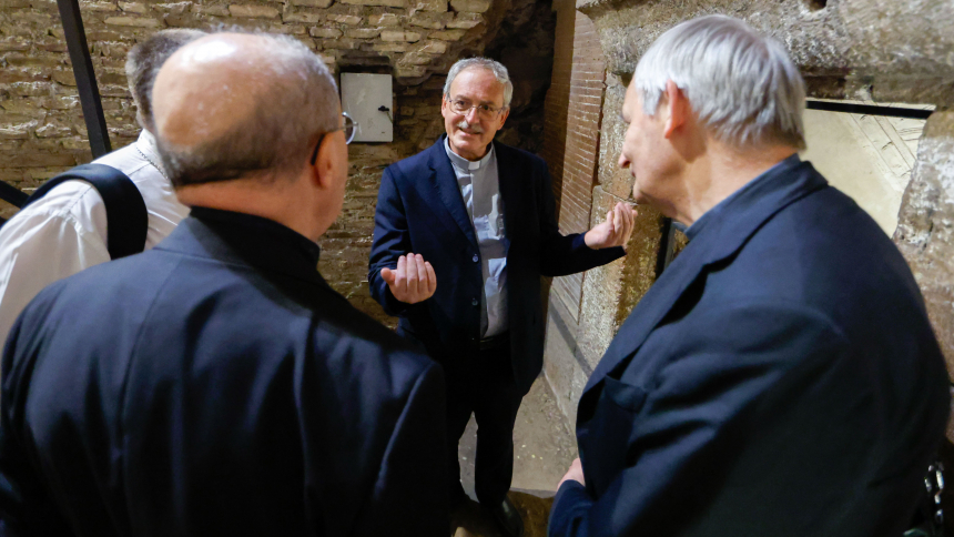 Msgr. Pasquale Iacobone, president of the Pontifical Commission for Sacred Archeology, gives a tour of Rome's Catacombs of St. Sebastian to Cardinal Matteo Zuppi, president of the Italian bishops' conference, and Archbishop Bruno Forte of Chieti-Vasto, Italy, as part of a pilgrimage with participants in the assembly of the Synod of Bishops, Oct. 12, 2023. (CNS photo/Lola Gomez)