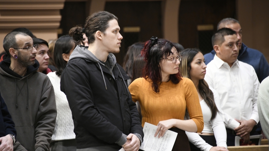 Among Christian candidates gathered at the Rite of Call, Jeremiah Martin (front, left), stands near his sponsor and fiancé Leah Taylor (front, right), both of Nativity of Our Savior in Portage, on Nov. 26 at the Cathedral of the Holy Angels in Gary. The seekers, presented at the liturgy to Bishop Robert J. McClory, will continue in their conversion with the assistance of sponsors, as they anticipate full communion with the Catholic Church. (Anthony D. Alonzo photo)