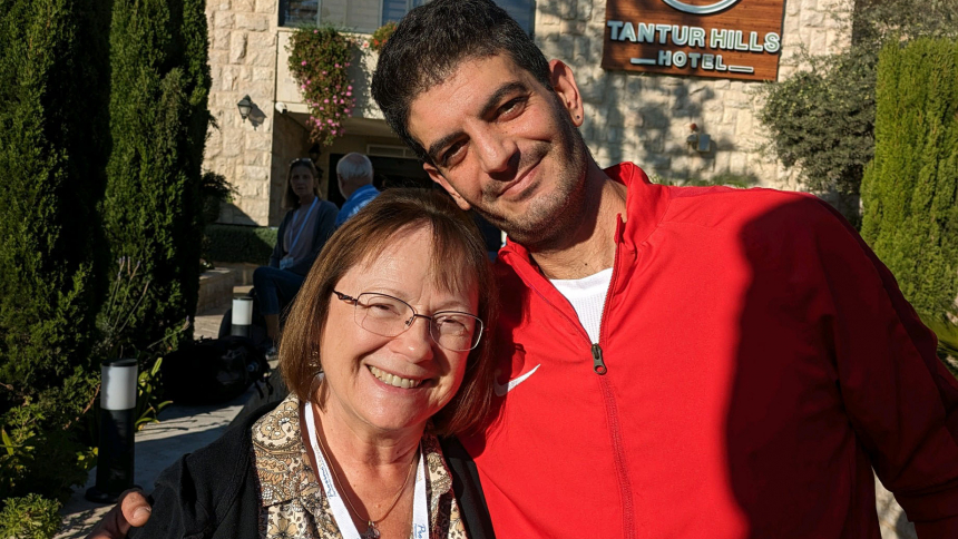 Vicki Huelat poses with Zaki outside the hotel Huelat and her pilgrimage tour group stayed at in Jerusalem. Huelat said Zaki claimed her as his adopted mother-in-law and Huelat considers him as her adopted son-in-law. (Photo provided)