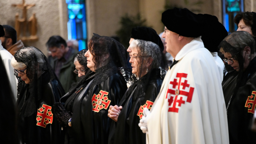 Members of The Equestrian Order of the Holy Sepulchre of Jerusalem of the Diocese of Gary attend Mass in their formal regalia at St. Thomas More church in Munster on Oct. 21. The knights and dames of the only lay institution tasked by the Holy See to support the charitable, educational and evangelization endeavors of the Latin Patriarchate of Jerusalem met for the liturgy and a conference dinner where discussion about the outbreak of violence around the Holy Land was a prime topic.  (Anthony D. Alonzo photo