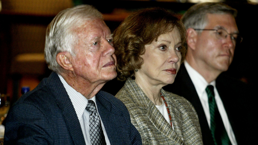 Former U.S. President Jimmy Carter, left, along with his wife Roslyn Carter, center, and John Hardman, executive director of The Carter Center in Atlanta, listen to participants speak at the center during a "Finding Democracy in the Americas" summit March 17, 2003. Mrs. Carter died Nov. 19, 2023, at age 96. (OSV news photo/Tami Chappell, Reuters)