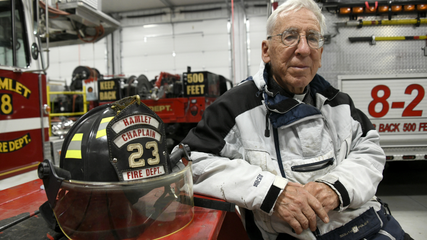 Father Anthony Spanley sits in the firehouse of the Hamlet-Davis Township Volunteer Fire Department, where he serves as a chaplain, in Hamlet on Nov. 3. The 81-year-old pastor of Holy Cross and St. Dominic Mission in Koontz Lake was recently presented the Schricker Service Before Self Award by the Starke County Chamber of Commerce for his commitment to volunteerism and concern for his neighbors. (Anthony D. Alonzo photo)