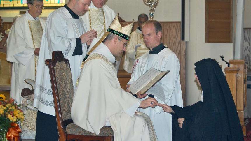 Dom Geoffroy Kemlin, abbot president of the Benedictines' Solesmes Congregation in France, places a ring on the finger of Benedictine Mother Benedict McLaughlin, abbess of Immaculate Heart of Mary Abbey in Westfield, Vt., during her Nov. 11, 2023, abbatial blessing. (OSV News photo/Cori Fugere Urban, Vermont Catholic magazine)