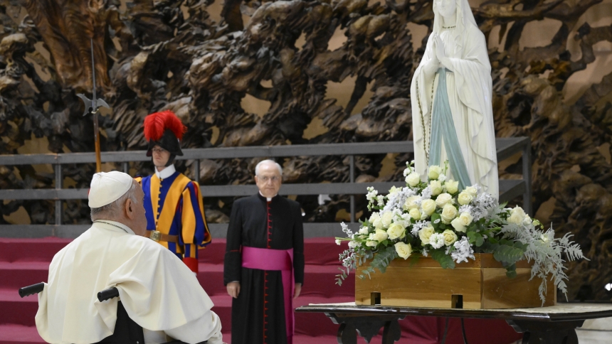 Pope Francis prays in front of a statue of Our Lady of Lourdes during a meeting with UNITALSI, an Italian Catholic association that organizes pilgrimages for the sick and for people with disabilities, in the Paul VI Audience Hall at the Vatican Dec. 14, 2023. (CNS photo/Vatican Media)