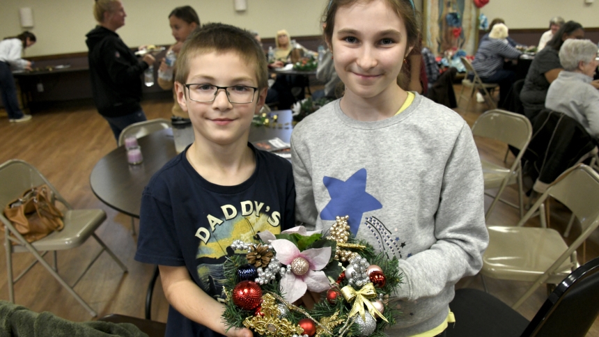 Rusin siblings Chris (left), 7, and Kinga, 10, display the Advent wreath they decorated at a workshop at Holy Name of Jesus on Nov. 11. The Cedar Lake parish hall played host to the Crafting with a Purpose session, where coordinators reminded participants about the faith-affirming meaning of the festive trim. (Anthony D. Alonzo photo)