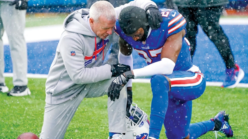 Len Vanden Bos, chaplain of the Buffalo Bills, is pictured in an undated photo praying with a player. While an Orchard Park-based Catholic priest frequently leads Saturday-evening Masses for the Catholics on the team, Vanden Bos - a nondenominational Christian - is entrusted with the task of providing pastoral care for the team on a daily basis. (OSV News photo/courtesy Len Vanden Bos)