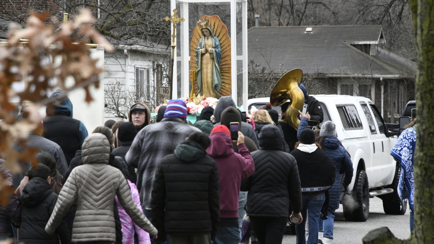 Faithful among more than 100 pilgrims follow a truck carrying a large statue of Our Lady of Guadalupe as they participate in the third intra-city “Great Guadalupana Walk” in Gary on Dec. 3. Catholics moved on foot or in vehicles as the large statue of the Blessed Mother was transported on a five-mile journey from Ss. Monica and Luke to St. Joseph the Worker where the novena celebration continued in the Glen Park neighborhood. (Anthony D. Alonzo photo)