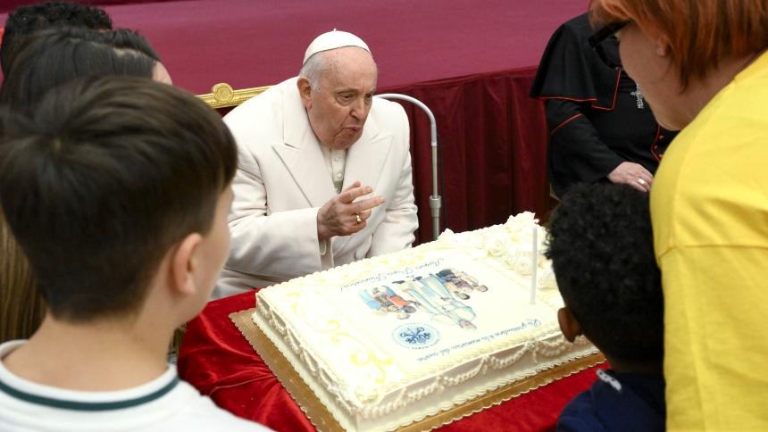 Pope Francis blows out the candles on his birthday cake in this file photo from an audience with children assisted by the Vatican's pediatric clinic in the Paul VI Audience Hall Dec. 17, 2023, his 87th birthday. (CNS photo/Vatican Media)