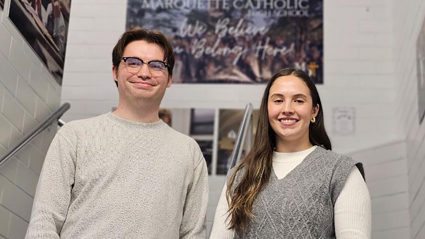 Spanish teacher Caleb Sheets (left) and assistant athletic director Emmery Joseph (right) stand in a stairwell at Marquette Catholic High School on Jan. 11 in Michigan City. Both excited to be at their alma mater, the collaegues each returned four years after their graduations - Sheets in 2022 and Joseph in 2023. (Bob Wellinski photo)