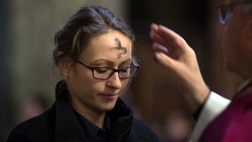 A woman is pictured in a file photo receiving ashes during Ash Wednesday Mass. Ash Wednesday falls on Valentine's Day in 2024. (OSV News photo/Marcin Mazur, Catholic Church England Wales)