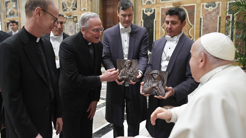 Pope Francis receives gifts from Holy Cross Father John I. Jenkins, president of the University of Notre Dame, center, and Holy Cross Father Robert A. Dowd, president-elect, left, during a meeting with the university's board of trustees at the Vatican Feb. 1, 2024. (CNS photo/Vatican Media)